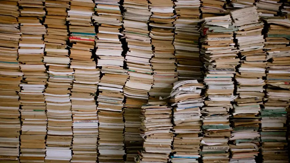Rows of vintage books piled in an organized manner, capturing literary history.